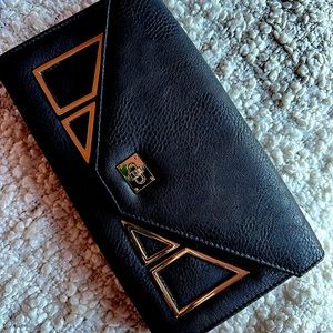 Stylish black clutch purse. Black with gold pieces